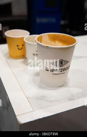 Madrid, Spain - Feb 16, 2025: Branded coffee cups on display at CoffeeFest, where top espresso machine makers like La Marzocco showcase their craftsma Stock Photo