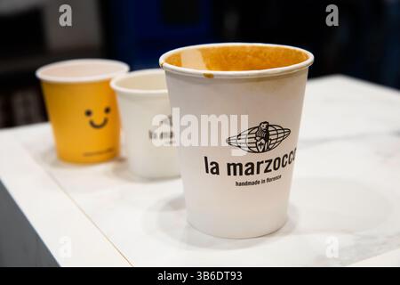 Madrid, Spain - Feb 16, 2025: Branded coffee cups on display at CoffeeFest, where top espresso machine makers like La Marzocco showcase their craftsma Stock Photo