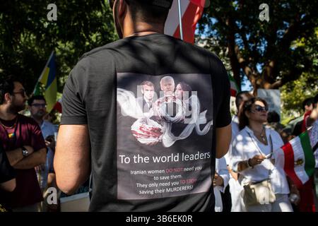 September 16, 2023, Washington, District of Columbia, United State: A demonstrator  wearing a T-shirt with To the world leaders, Iranian women DO NOT need you to save them. They only need you TO STOP saving their MURDERERS! written on it, take part in a demonstration to mark the Mahsa Amini's first death anniversary in Washington DC. Mahsa Amini, a 22-year-old Iranian woman died unexpectedly on September 16, 2022 in police custody after violating the Iranian Islamic Regime's imposed dress code for women, sparking mass protests and ensuing arrests and executions. Some 500 people were killed, in Stock Photo