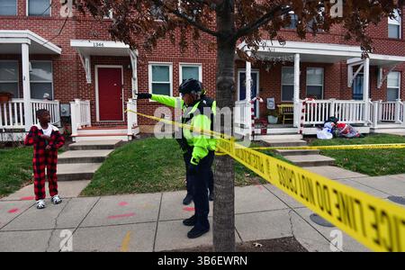 December 21, 2023, Washington, District of Columbia, USA: A quadruple shooting left two dead and two critically wounded at the Friendly Food corner market near Nationals Park. Trish Harris, 35, died at the scene and leaves behind three children just days before the Christmas holiday. Also killed was Tyrone Jacobs, 24, whose son will turn 5 on New Year's Eve. It is suspected a vehicle that had been carjacked was used in the killing. It was later found torched. Dozens of shell casings littered the road and sidewalk, and large bullet holes tore through a mural on the wall of the market after the Stock Photo