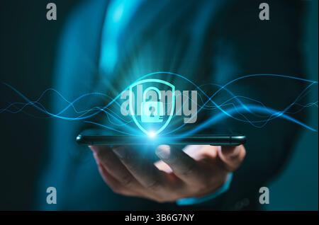 Technology Concept of Cybersecurity. A businessman is using a smartphone to access and validate a password for biometric two-step authentication to un Stock Photo