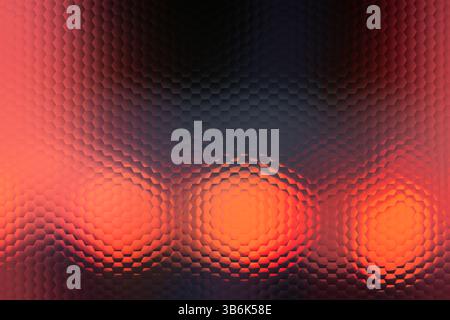 A blurry image of three orange circles with a red background. The circles are all different sizes and are overlapping each other. The image has a drea Stock Photo