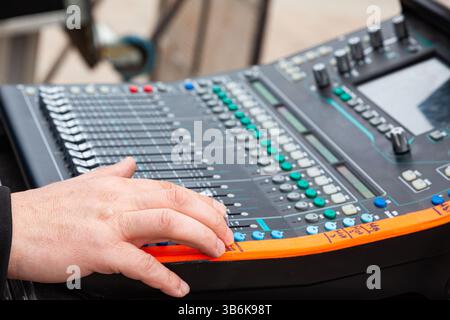 Professional music mixer with dj's hand. DJ remote control for music. Stock Photo