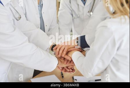 Medical doctor team staff common high five together, corporate clinic workers join hands in success Stock Photo
