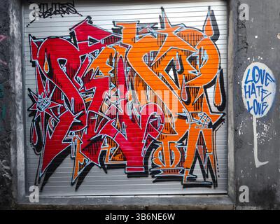 A graffiti work created by the artist on the rolling door of a shop Stock Photo