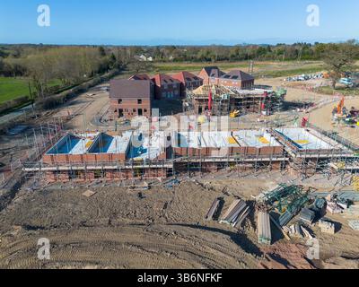 Aerial view of a residential construction site with tower cranes and ...