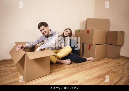 Young couple unpacking boxes in a living room Stock Photo