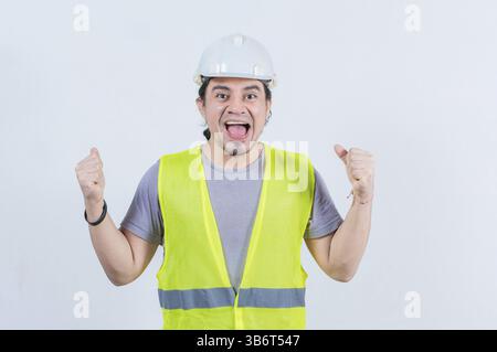 Happy engineer celebrating on isolated background. Excited engineer gesturing celebration isolated Stock Photo