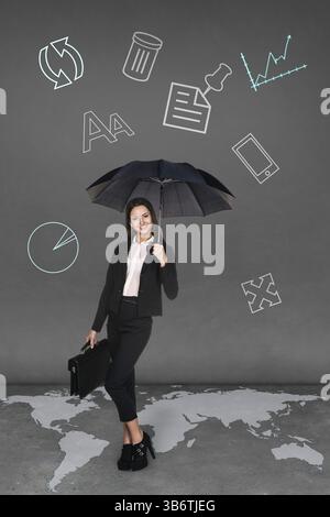 Pretty businesswoman holding umbrella on grey background. Map from NASA http://visibleearth.nasa.gov/view rec.php?id=2433 Stock Photo