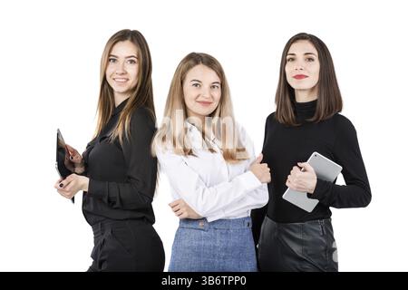 Three smiling business women standing in a row isolated on white background. Business Group people. Happy Business Team. Businesspeople Isolated On Wh Stock Photo