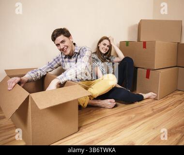 Young couple unpacking boxes in a living room Stock Photo