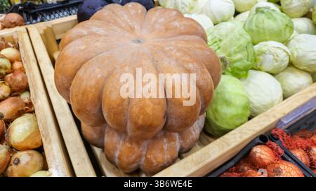 Pumpkin, cabbage and other vegetables on the counter in the supermarket. Prepared for sale. Healthy food. Product display Stock Photo