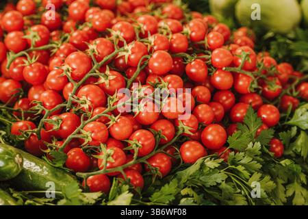 Fresh bio red ripe cherry tomatoes in a street food market, close up Stock Photo