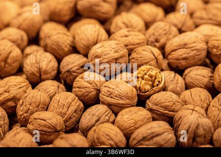 Walnuts in a fruit and vegetable street market, a walnut is open and the kernel is visible Stock Photo
