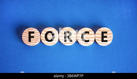 Force symbol. Concept word Force on beautiful wooden circles. Beautiful blue table blue background. Business lifestyle force concept. Copy space. Stock Photo
