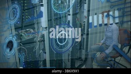 Image of processing circle over data and caucasian woman checking computer wires Stock Photo