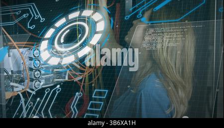 Image of processing circle over data and caucasian woman checking computer wires Stock Photo