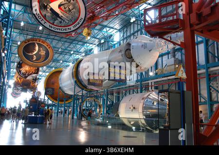 Saturn V rocket and Apollo mission patches on display at Kennedy Space Center, showcasing the command and service modules Stock Photo
