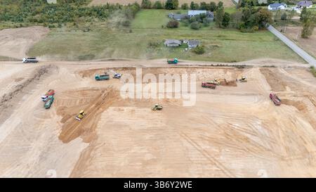Aerial view of a construction site with heavy machinery working on land grading. Stock Photo