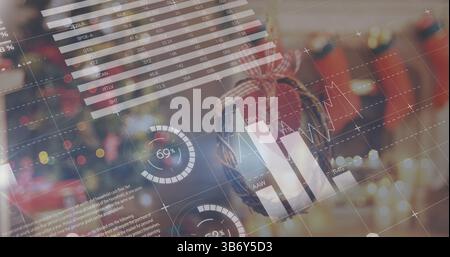 Image of graphs and numbers over christmas decoration Stock Photo