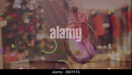 Image of graphs and numbers over christmas decoration Stock Photo