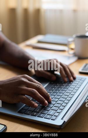 Hands Of Unrecognizable Man Typing on Laptop at Work Stock Photo