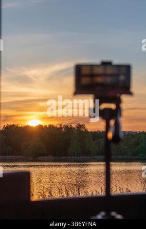 Cell phone on the tripod capturing sun set moment Stock Photo - Alamy