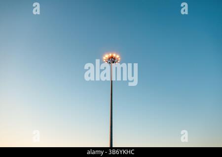 Tall lamppost with twelve LED lamp lights in circular pattern, low angle view Stock Photo