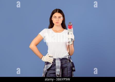 Ready For Renovation. Confident Couple Of Repair Workers Holding Construction Dryer Stock Photo