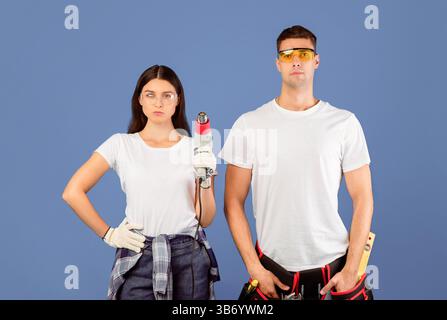 Ready For Renovation. Confident Couple Of Repair Workers Holding Construction Dryer Stock Photo