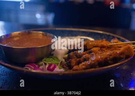 Malaysian style chicken satay with it's condiments Stock Photo - Alamy