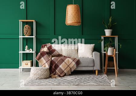 Interior of living room with sofa and knitted blanket Stock Photo