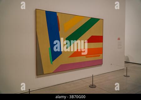 Abstract painting by Jack Bush featuring bold geometric shapes and vibrant colors displayed in a museum or art gallery setting. Stock Photo