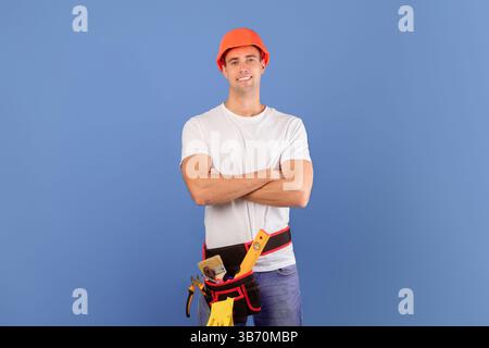 Confident young couple in hard hats ready for house repairment and renovation Stock Photo