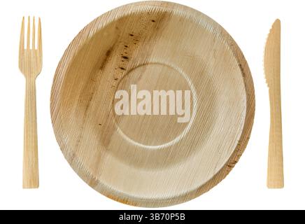Palm leaf disposable plates with matching birch wood cutlery knife and fork isolated on white background. Biodegradable compostable made from naturall Stock Photo