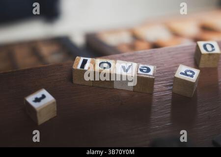 Wooden alphabet blocks spelling love on rustic wooden table. Stock Photo