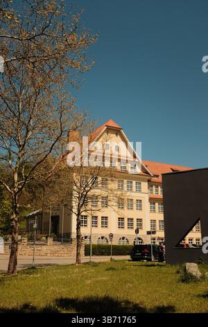 small town architectural elements with gravel path stone curb and decorative trees on sunny day. High quality photo Stock Photo