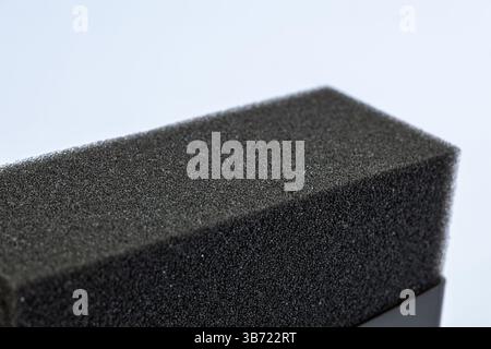 Texture of black tire shine foam applicator pad sponge close-up isolated on white background Stock Photo