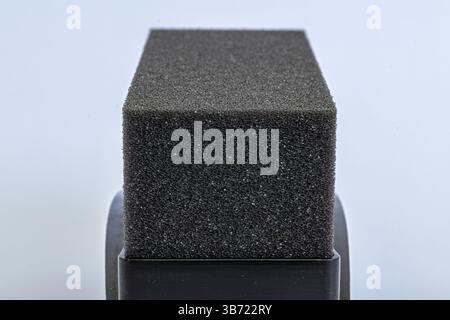 Texture of black tire shine foam applicator pad sponge close-up isolated on white background Stock Photo
