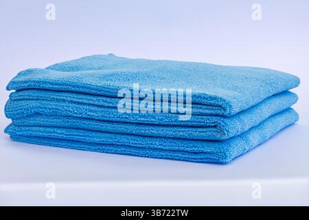 Three blue low pile height microfiber towels stack isolated on white background Stock Photo