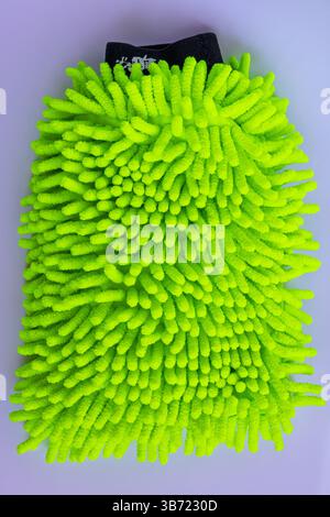 Green microfiber car wash mitt with tendrils isolated on white background, car wash detailing Stock Photo