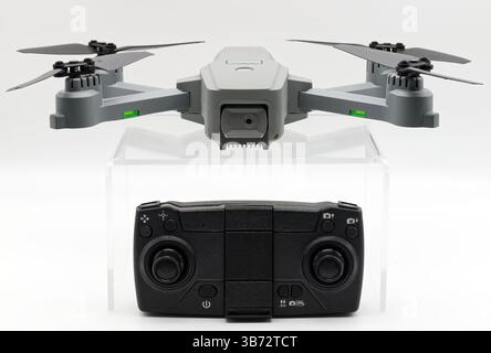 Gray drone and remote control isolated on white background. Stock Photo