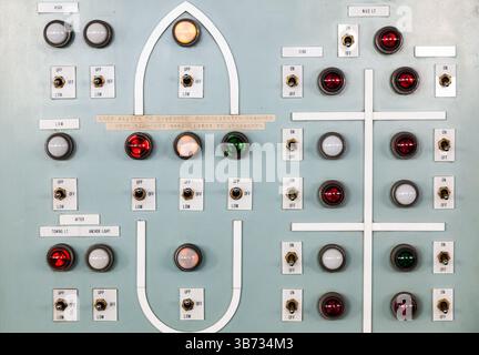Shipboard emergency switchboard supplying electrical equipment. Bulbs, buttons and switches on the electrical distribution board. Stock Photo