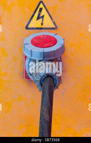 Electrical box with a high-voltage cable connected to it. Stock Photo