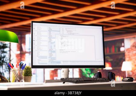Lines of code written on PC workstation display on development tool application, close up. Debugging software programming language displayed on computer monitor in living room office Stock Photo