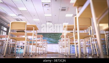 classroom with chairs and desks facing chalkboard 3d Stock Photo