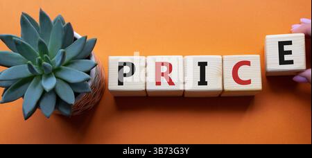 Price symbol. Wooden cubes with word Price. Businessman hand. Beautiful orange background with succulent plant. Businessman abd Price concept. Copy sp Stock Photo