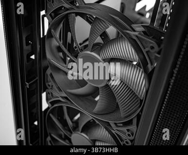 Two large PC cooling fans mounted vertically inside a computer case Stock Photo