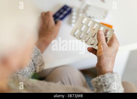 Senior woman taking her medication Stock Photo