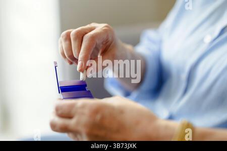Senior woman taking her medication Stock Photo